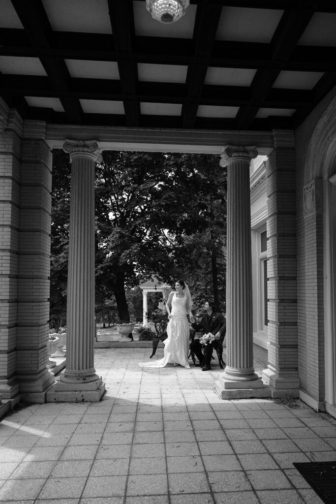 bride and groom in historic archway of historic mansion on wedding day