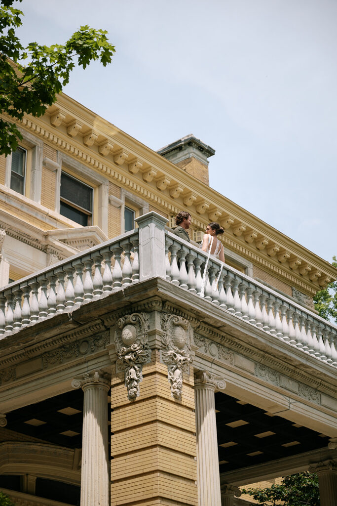 bride and groom, vintage historic estate wedding on balcony of cotton mansion in duluth, minnesota