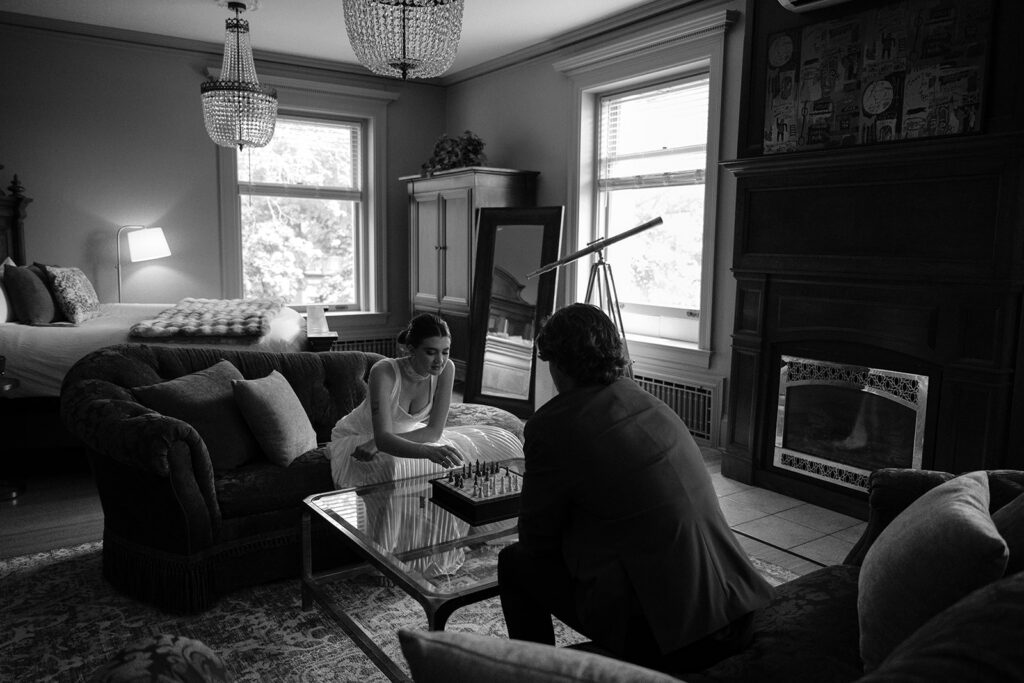 bride and groom playing chess inside historic estate the cotton mansion