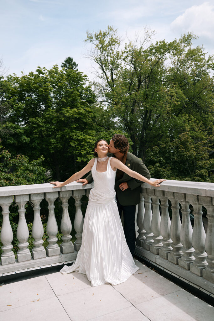 bride and groom, vintage historic estate wedding on balcony of cotton mansion in duluth, minnesota
