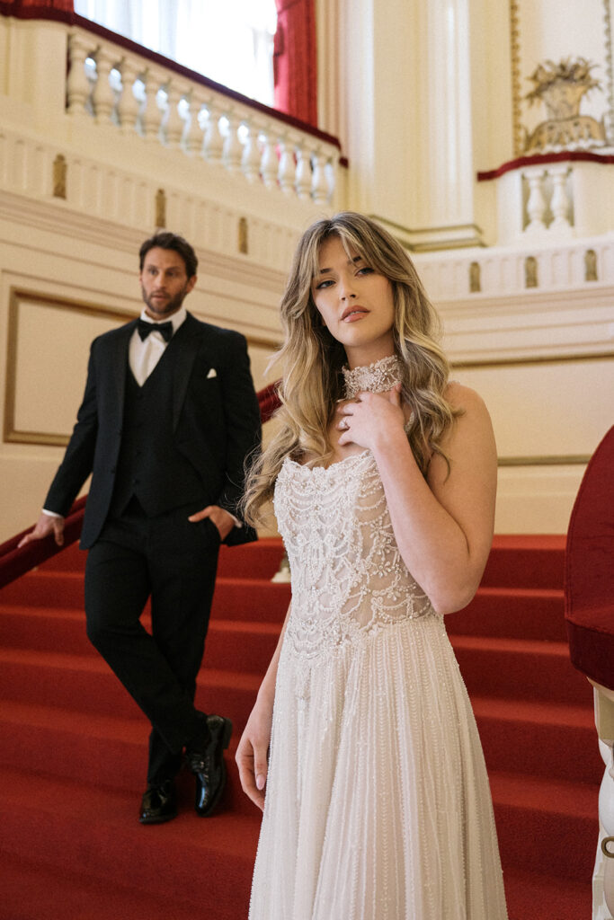 historic wedidng venue with bride and groom, watters designer dress with choker 