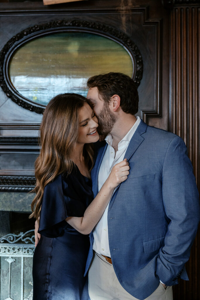 Romantic engagement session at Sasha’s Wine Bar in St. Louis with candid couple laughing together