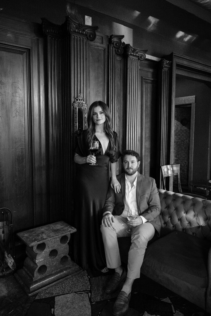 Moody documentary-style engagement photos in St. Louis wine bar with navy dress and editorial feel