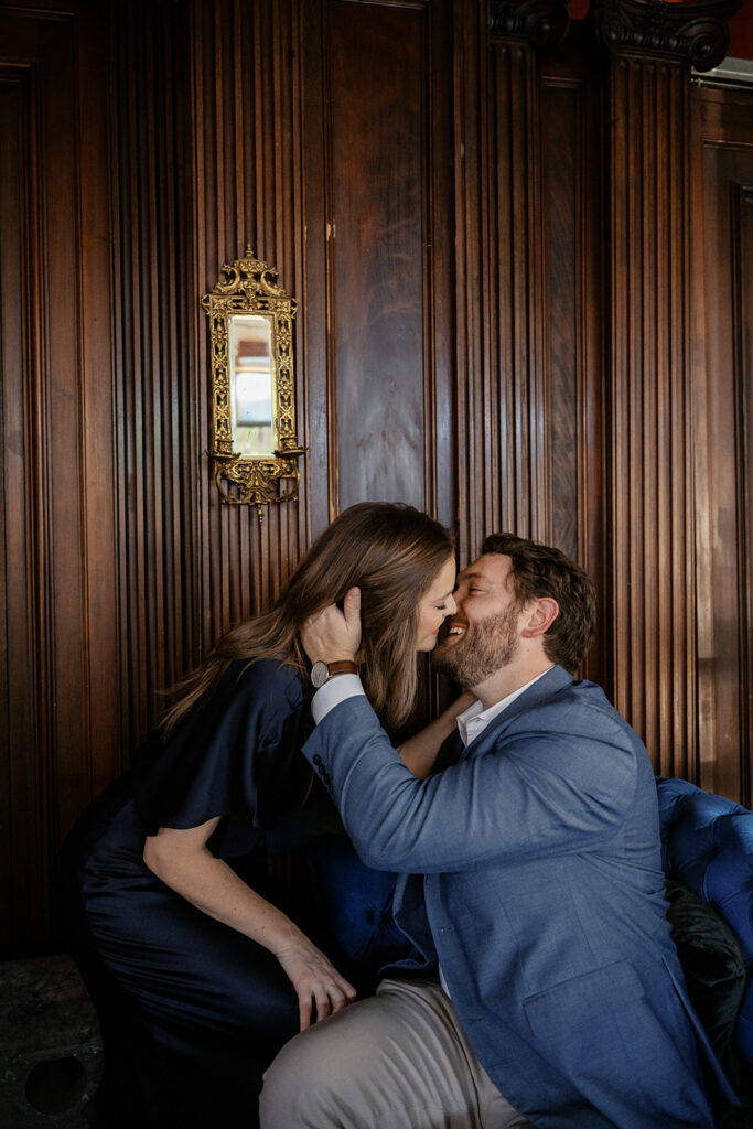 Romantic engagement session at Sasha’s Wine Bar in St. Louis with candid couple laughing together